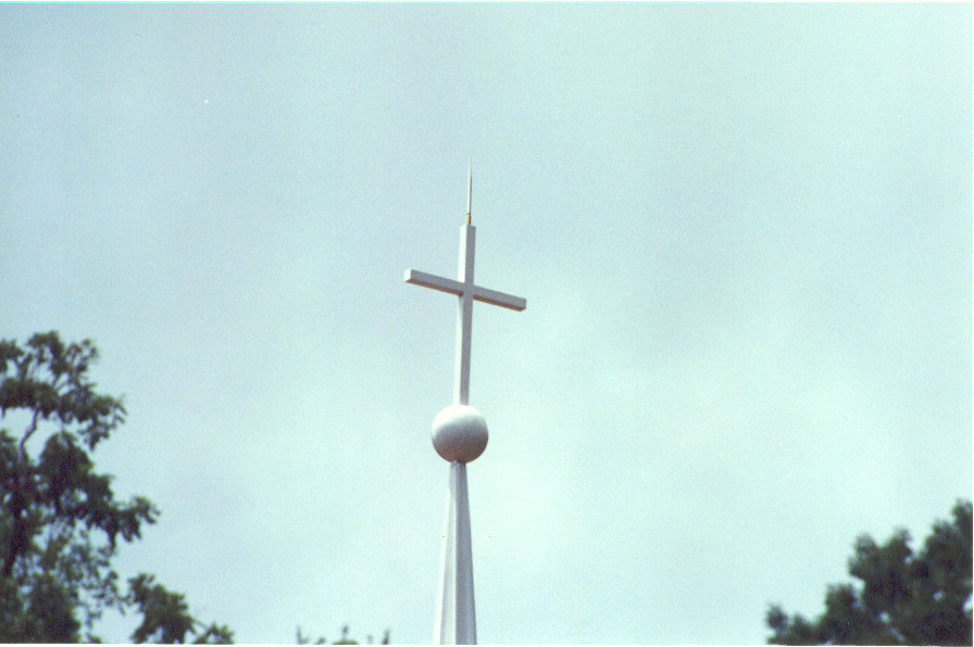 The Cross On The Very Top Of The Steeple